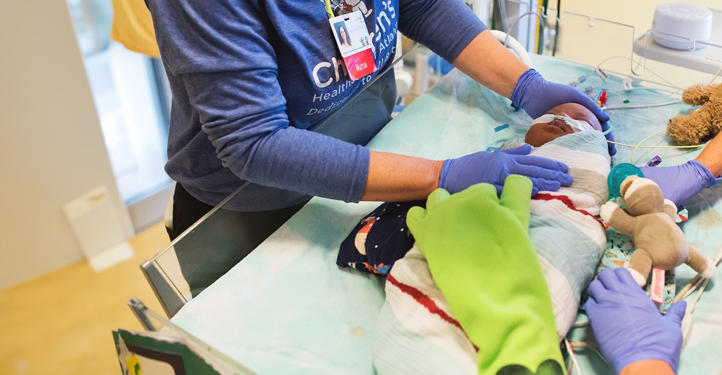 Nurses in CICU tend to patient after heart surgery