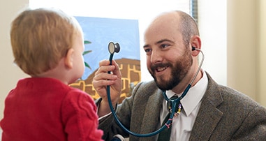 Dr. David O’Banion examining little boy at Marcus Autism Center