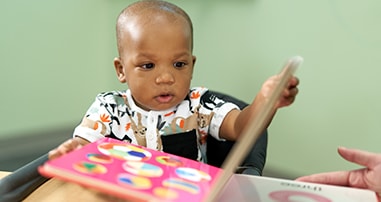 Little boy reading book at brain health center