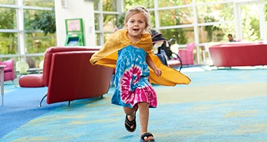 girl patient running through pediatric hospital in cape