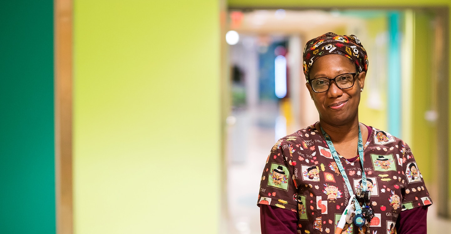 Children’s nurse smiling in the hallway