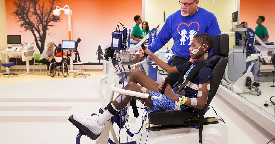 Teen in inpatient rehabilitation learning to walk