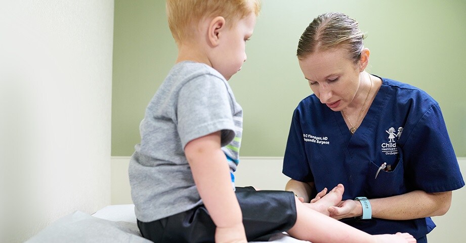 Dr. Flanagan examines a patient's foot in clinic