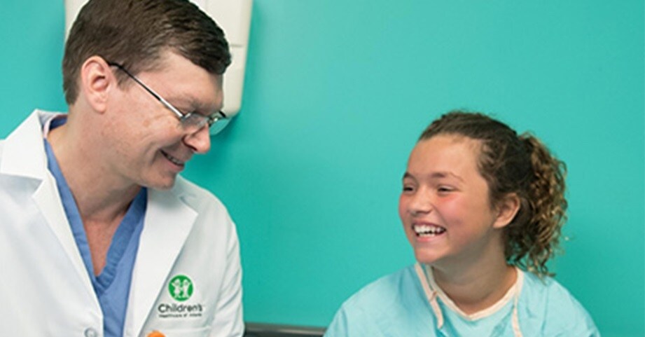 Dr. Schrader visits a hip patient before surgery.