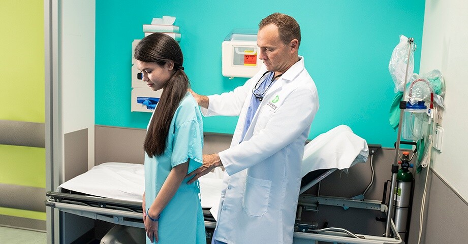 Dr. Schmitz with teen spine patient before surgery.