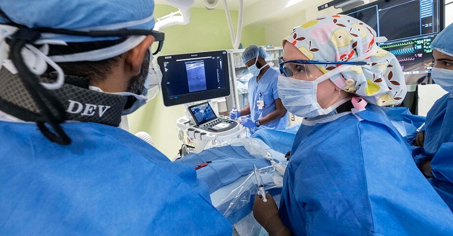 Interventional radiologists performing procedure.