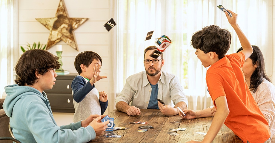 Boy getting upset while playing board game with family