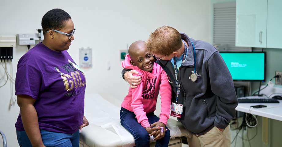 Parent with child and doctor in clinic room