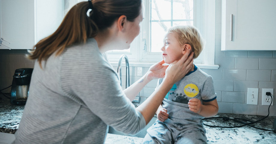 mom safely cleaning child's ears