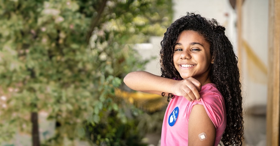 girl smiling after getting covid vaccine