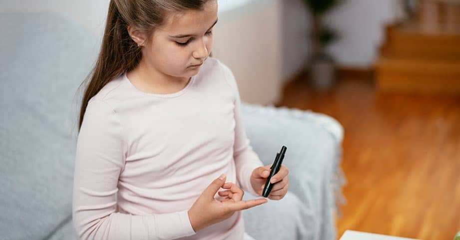 Child checking their blood sugar