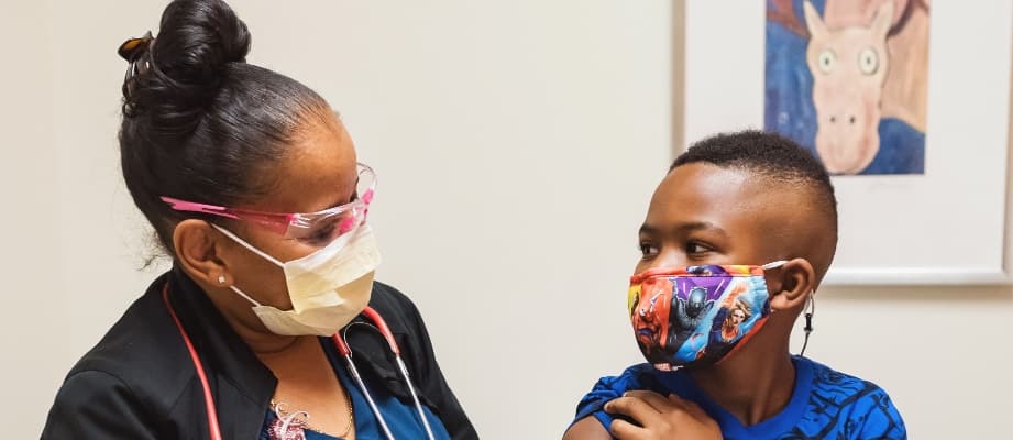 child with nurse after vaccine