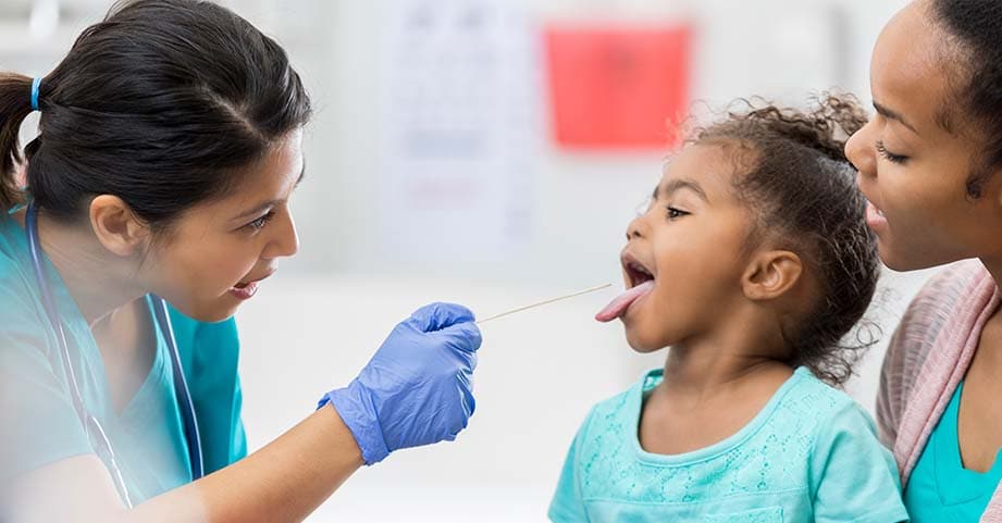Pediatric ENT examines a patient for strep throat. 