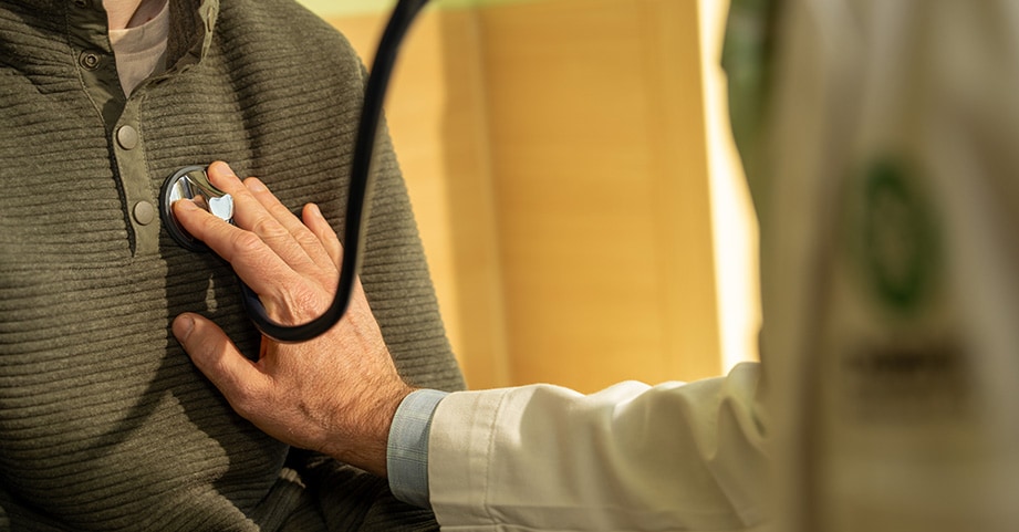 Heart doctor listens to a teens heart in an outpatient office 