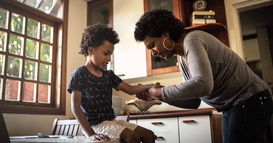 Parent contemplating whether her child's arm is broken or not. 