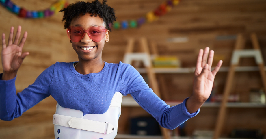 Young girl wearing scoliosis brace