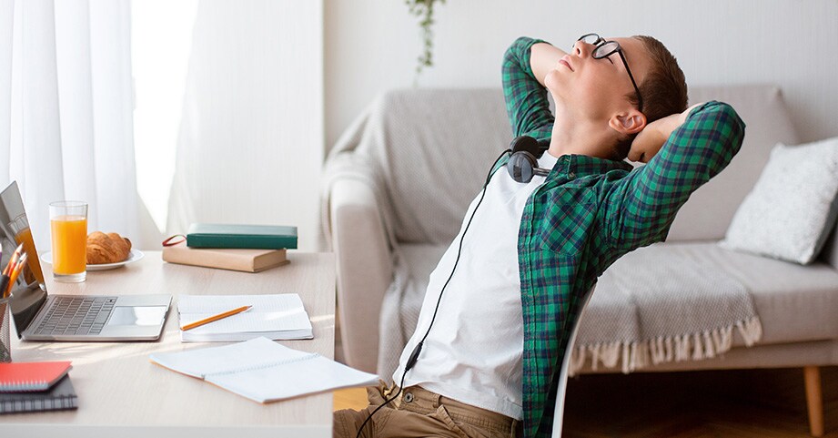 Teen stretching in front of computer