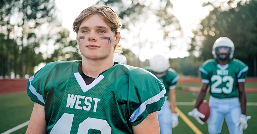 Teen athletes playing football