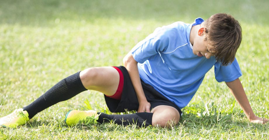 teen soccer player experiencing overuse injury