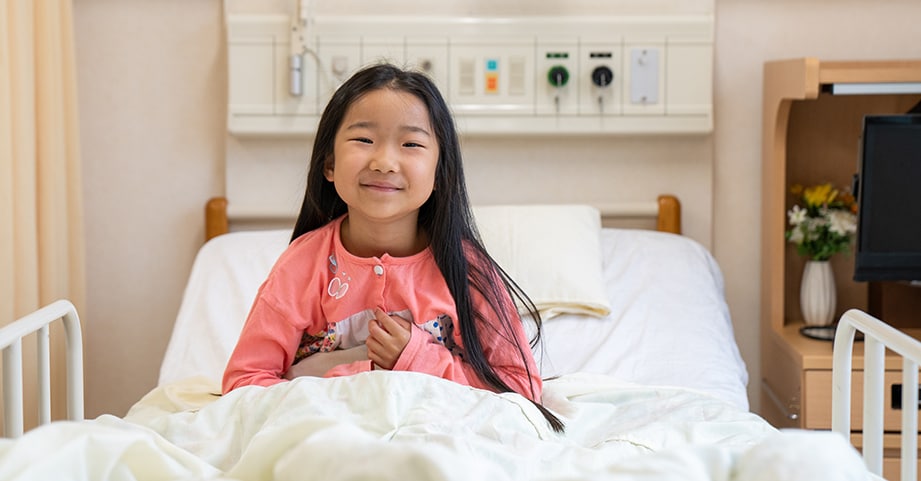 girl lying in hospital bed after surgery