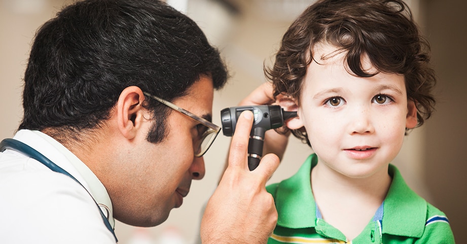 Otolaryngologist looking in childs ear