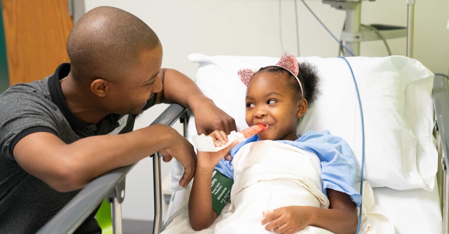 Dad with little girl after surgery