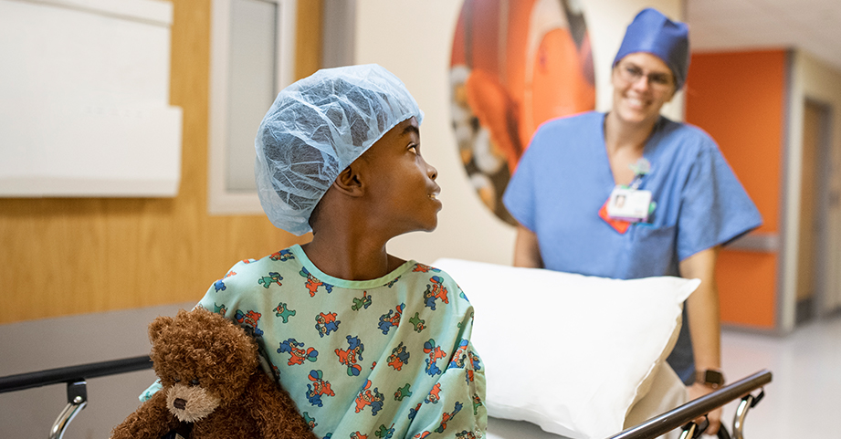 child being wheeled into surgery