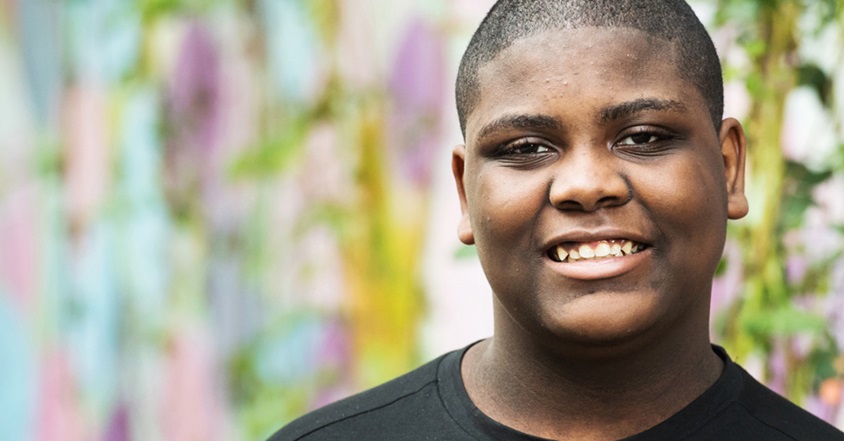 boy smiling outside wearing black shirt