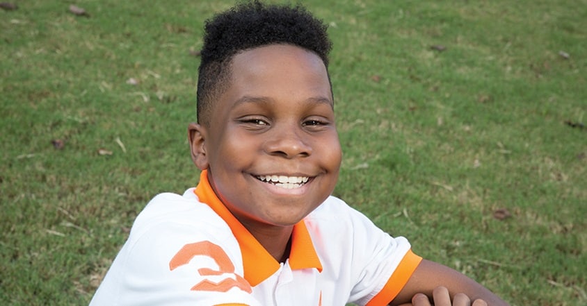 Larenz Soares, a teen boy with sickle cell disease, is smiling