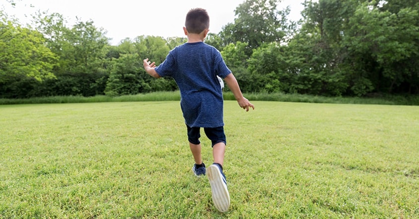 Boy with pediatric seizures playing soccer outside