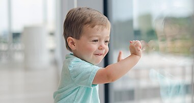 boy looking out pediatric hospital window