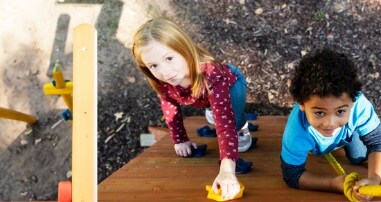 Toddlers in the park on rock wall