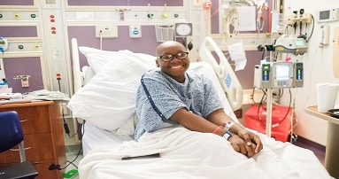 Child sitting in hospital bed