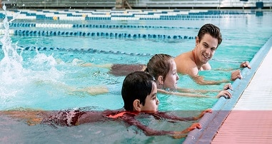 Swim instructor with children in pool