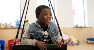young child on swings