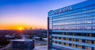 sun setting behind Arthur M. Blank Hospital