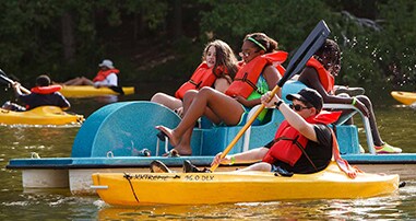 Campers paddling on lake at Strong4Life Summer Camp