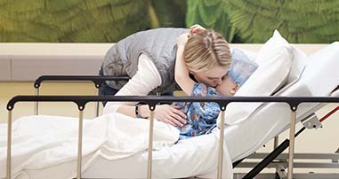 Mom giving her son a kiss before he goes into surgery in pediatric hospital
