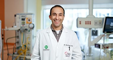 Pediatric doctor smiles in patient room at hospital