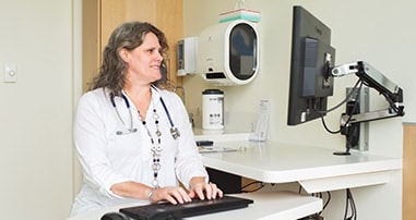 Pediatric Pulmonologist working at desk