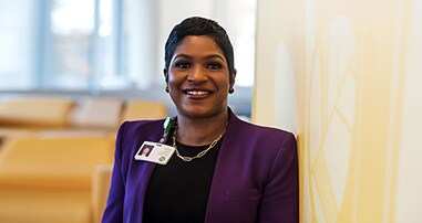A doctor looks over a nurse’s shoulder at the nurse station