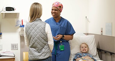 doctor talking to mom in patient room