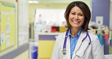 Children's female physician standing in hospital