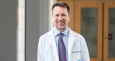 Dr. Graham smiling in hallway
