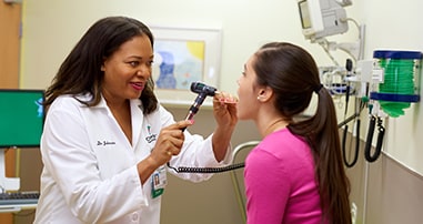 Pediatric doctor examining patient in clinic