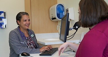 Dr. Ann-Marie Brooks sitting at computer 