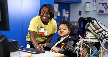 Pediatric rehab patient smiling with nurse