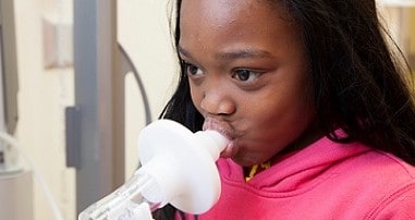 Girl in asthma clinic undergoing breathing treatment