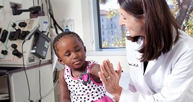 little girl sickle cell disease patient giving her doctor a high five