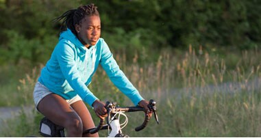teen girl riding bike outside